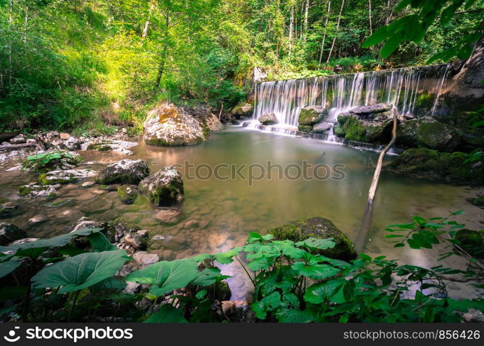 Beautiful mountain waterfall in the forest, long time exposure. Austria.