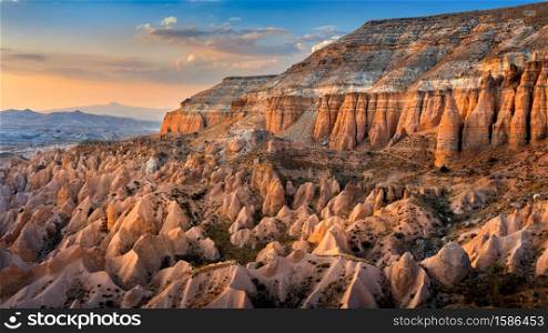 Beautiful mountains and Red valley at sunset in Goreme, Cappadocia in Turkey.