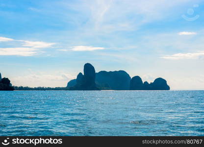 beautiful mountains covered with green trees and blue calm sea on a sunny day, Thailand, Krabi province