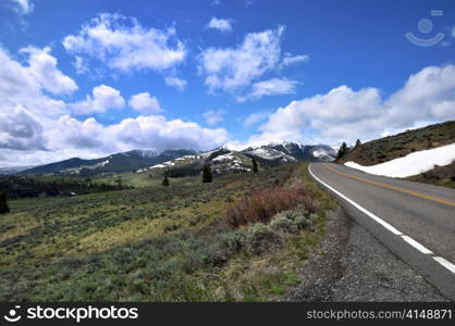 beautiful mountains landscape with road and snow