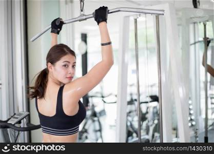 beautiful muscular fit woman exercising building muscles and fitness woman doing exercises in the gym. Fitness - concept of healthy lifestyle,soft focus
