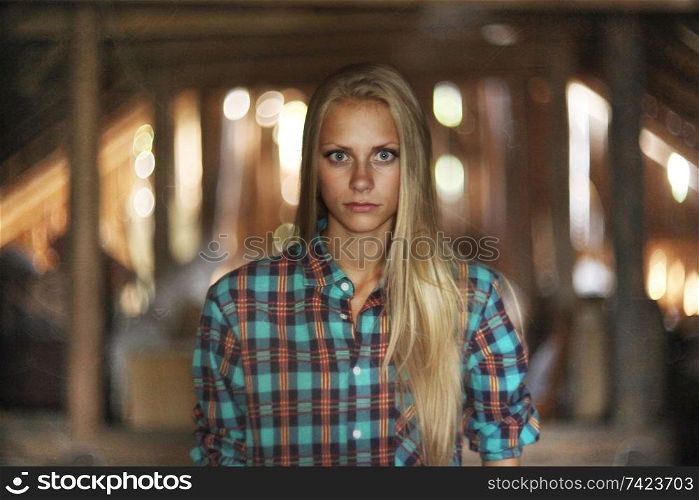 beautiful mysterious young woman in the attic in a wooden house with ghosts