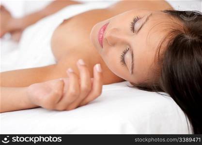Beautiful naked woman sleeping in white bed, shallow DOF