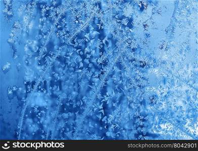 Beautiful natural blue ice pattern on winter glass