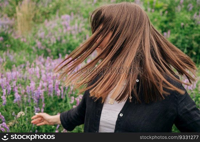 Beautiful natural hair. Woman shaking head, dancing on nature background. High quality photo. Beautiful natural hair. Woman shaking head, dancing on nature background.