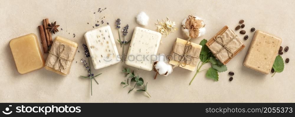 Beautiful Natural soap bars and ingredients on beige background, top view. Handmade organic soap concept, banner. Natural soap bars and ingredients on beige background, flat lay