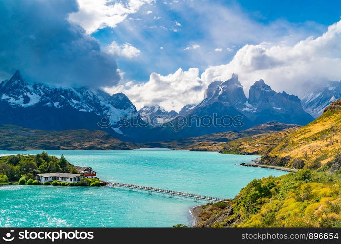 Beautiful natural view of Lake Pehoe and Cuerno del Paine Mountains with rain clouds in the sky at Torres del Paine National Park in, Chile.