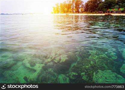 Beautiful nature landscape colorful the sunlight at the sunrise in summer over the clear sea, see the coral reef, beache, tree, resort at North Point Beach, Koh Lipe island, Tarutao, Satun, Thailand. Sunrise over the sea at North Point Beach, Koh Lipe , Thailand