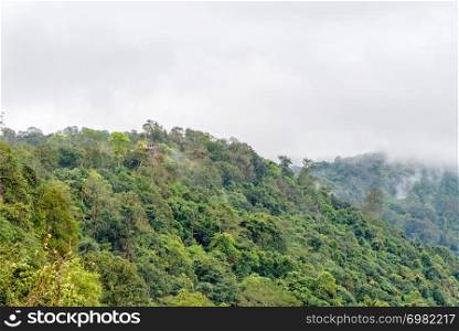 Beautiful nature landscape of green forests and peaks of Pha Chu Thong look from a distance at Lan Hin Pum is a famous nature attractions of Phu Hin Rong Kla National Park, Phitsanulok, Thailand. Pha Chu Thong Peak looking from the distance