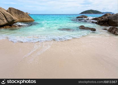 Beautiful nature of blue sea sand and white waves on small beach near the rocks during summer at Koh Miang island in Mu Ko Similan National Park, Phang Nga province, Thailand