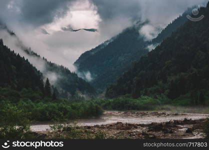 Beautiful nature of Georgia. Amazing foggy mountaind with deep forest and Rioni River in Racha.