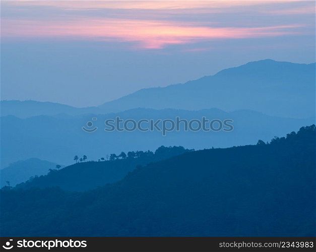 Beautiful nature of sunrise and mountains complex with morning mist atmosphere at Tak, Thailand.