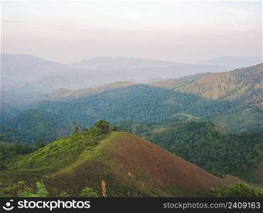 Beautiful nature of sunset and mountains complex with evening atmosphere at Tak, Thailand.