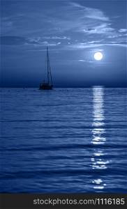 Beautiful night Adriatic sea, yacht and full moon, Croatia. Night seascape. Trendy banner toned in classic blue - color of the 2020 year. Beautiful night Adriatic sea, yacht and full moon, Croatia. Night seascape.