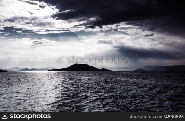 Beautiful night seascape, abstract natural background, dramatic cloudscape, island in moonlight, mysterious water landscape, magic night