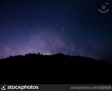 beautiful night sky from milky way galaxy with stars and meteor over mountain at national park, Thailand on February 2020