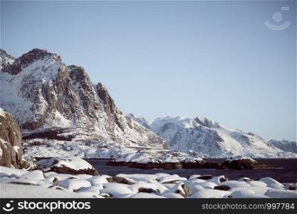 beautiful Norwegian landscape at the Lofoten Islands. Norway. beautiful snowy mountains and the shore of the fjord