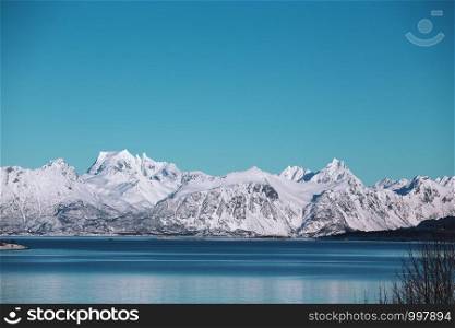 beautiful Norwegian landscape at the Lofoten Islands. Norway. beautiful snowy mountains and their reflection in the fjord