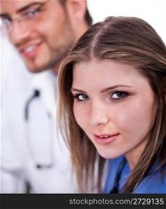 Beautiful nurse looking with the similing doctor in the background