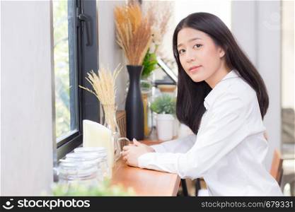 Beautiful of portrait asian young woman working online sitting at coffee shop, professional female freelancer relax and leisure, business concept.