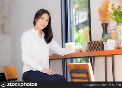 Beautiful of portrait asian young woman working online sitting at coffee shop, professional female freelancer relax and leisure, business concept.