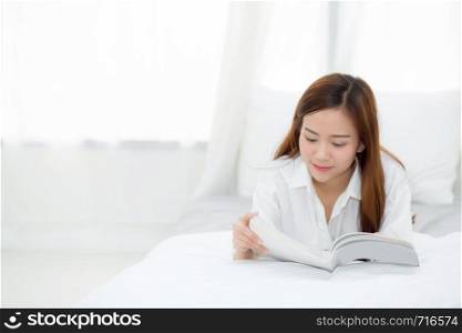 Beautiful of portrait young asian woman relax lying reading book on bedroom at home, girl study literature, education and lifestyle concept.