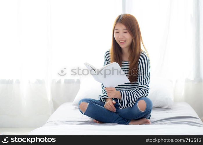 Beautiful of portrait young asian woman relax sitting reading book on bedroom at home, girl study literature, education and llifestyle concept.