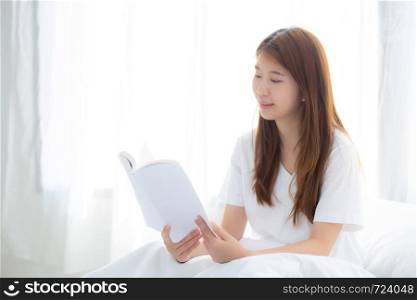 Beautiful of portrait young asian woman relax sitting reading book on bedroom at home, girl study literature, education and llifestyle concept.