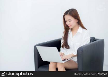Beautiful of portrait young asian woman using laptop for leisure on sofa, girl working online internet with notebook freelance, communication business concept.