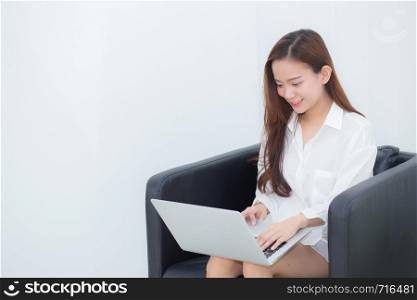 Beautiful of portrait young asian woman using laptop for leisure on sofa, girl working online internet with notebook freelance, communication business concept.