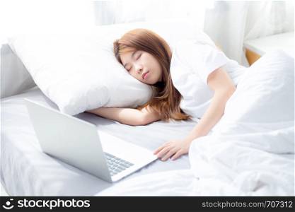 Beautiful of portrait young asian woman with laptop lying down in bedroom, girl tired sleep and relax with computer notebook, resting and healthcare concept.