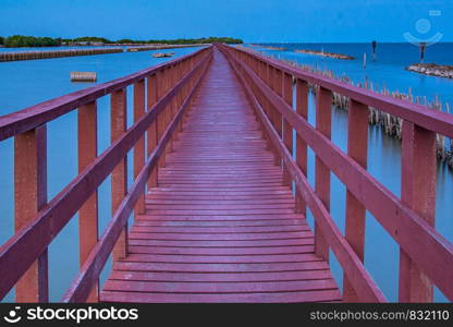 Beautiful of The walkway red wooden bridge in evening at Bang Khun Thian sea view, Bang Khun Thian, Bangkok, Thailand.