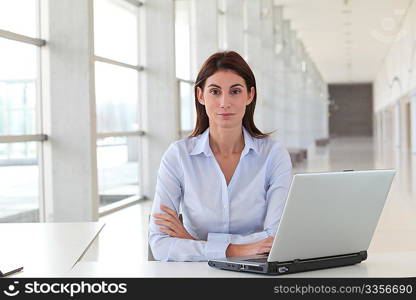 Beautiful office worker sitting at her desk