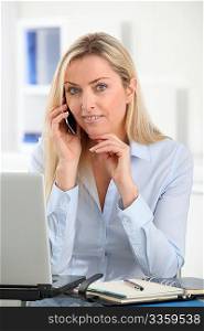 Beautiful office worker talking on the phone
