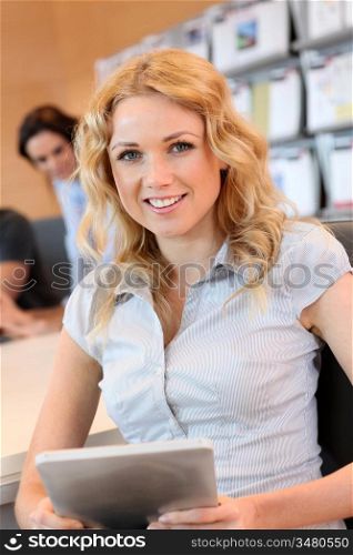 Beautiful office worker using tablet in office