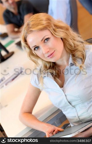 Beautiful office worker using tablet in office