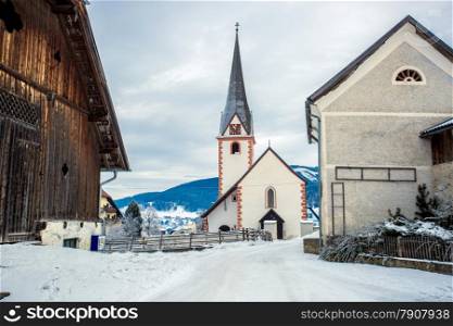 Beautiful old catholic church in small Austrian town covered by snow
