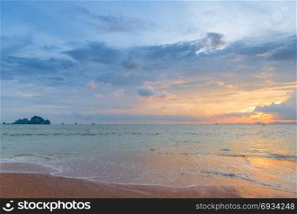 beautiful orange and pink sky during sunset over the calm sea in the resort of Thailand