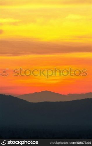 Beautiful orange and red sky over mountain range after sunset