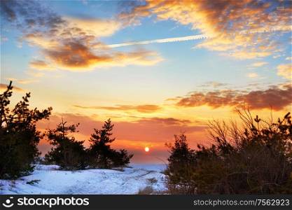Beautiful orange sunset in winter mountains with snow
