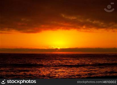 Beautiful orange sunset, peaceful sea coastline, dramatic red sunrise, paradise beach coast, calm ocean landscape, natural background, conception of holiday, tourism, vacation, travel&#xA;