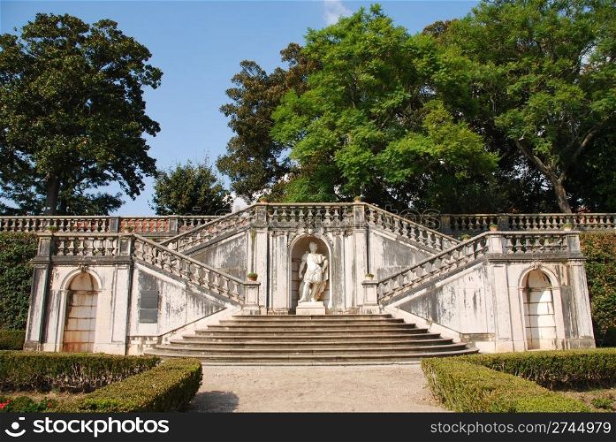 beautiful ornamental Ajuda garden with an antique staircase and statue in Lisbon, Portugal
