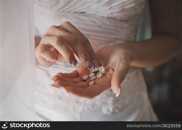 Beautiful ornaments in hands of the bride.