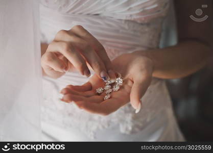 Beautiful ornaments in hands of the bride.