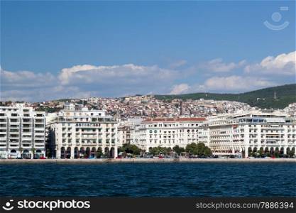 Beautiful panorama of coastal city with hilled country. View from ship or boat