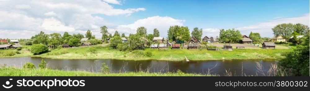 Beautiful panorama of Russian village on the river bank.