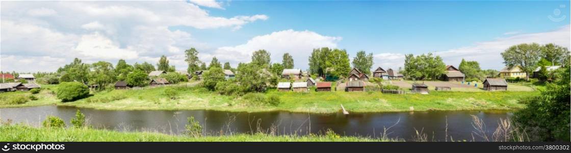 Beautiful panorama of Russian village on the river bank.