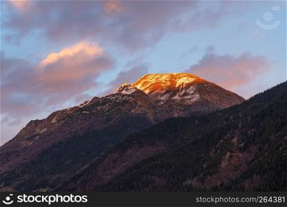 Beautiful panorama of the snow-covered Orobie mountains of the Seriana Valley and the Sedornia Valley at sunset.