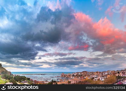 Beautiful panoramic view of Cala Marina, harbor in coastal city Castellammare del Golfo at sunset, Sicily, Italy. Castellammare del Golfo at sunset, Sicily, Italy
