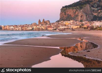 Beautiful panoramic view of the beach, Cefalu Cathedral and old town of coastal city Cefalu at sunset, Sicily, Italy. Cefalu at sunset, Sicily, Italy